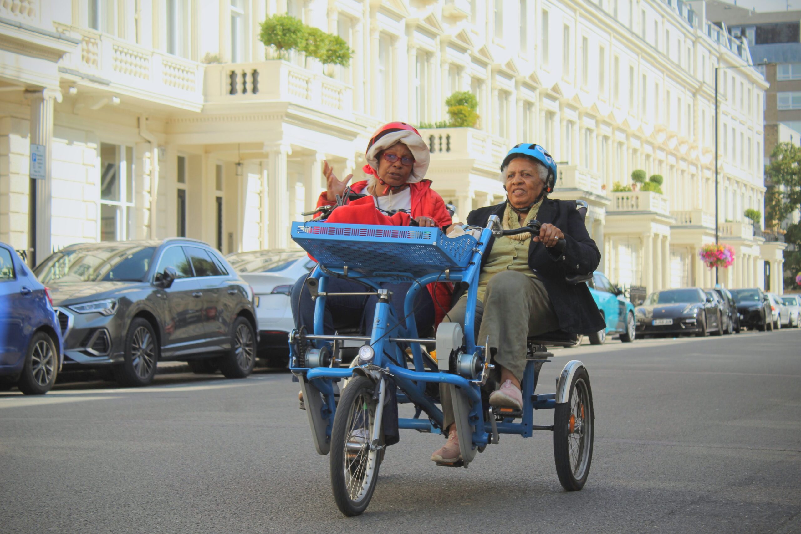 Side-by-side bicycle with pilot and passenger riding on a quiet street in Westminster